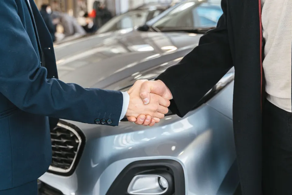 Two people shaking hands on a deal
